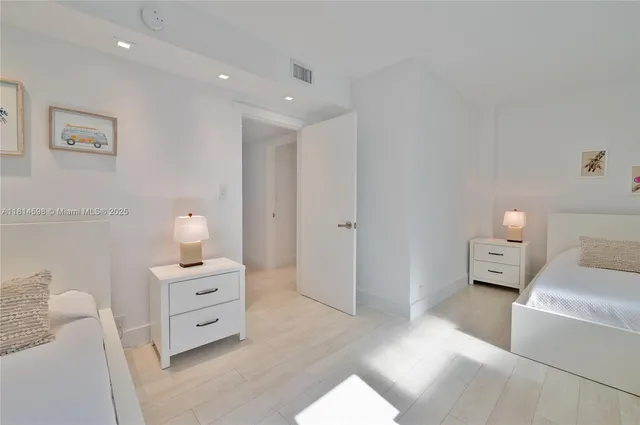 a spacious bedroom with a bed and a couch