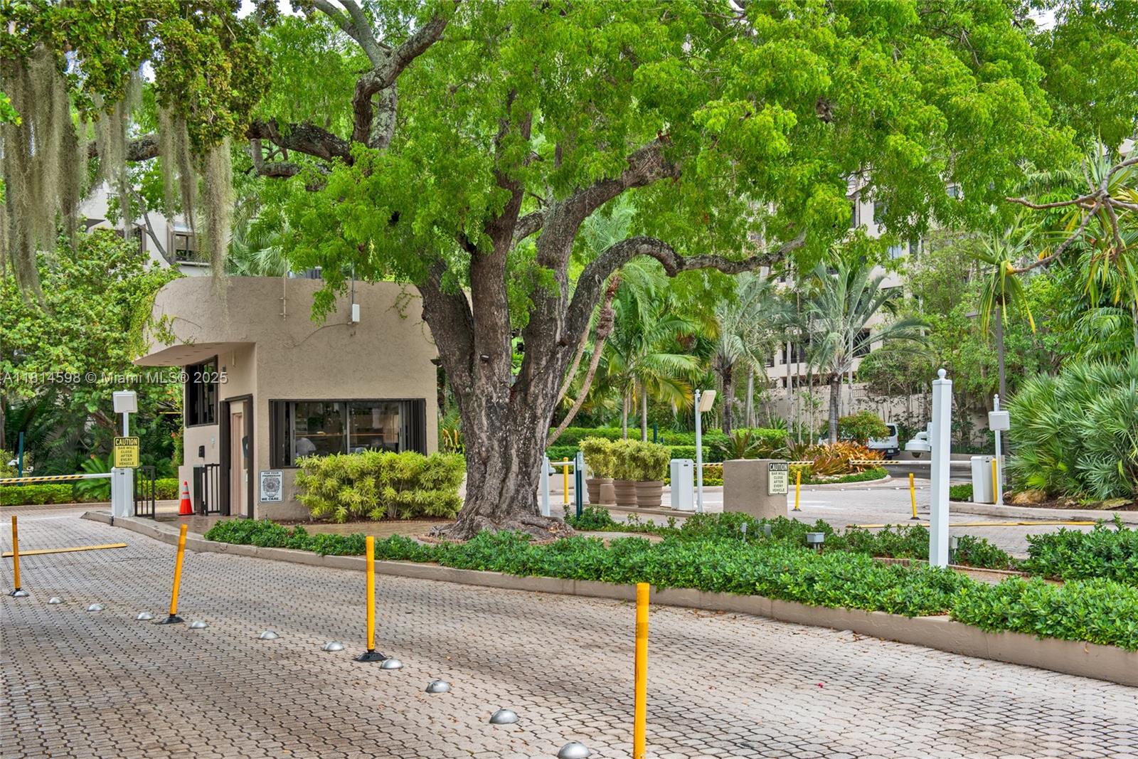 101 Crandon Boulevard, Unit 480 Key Biscayne, FL 33149 - Photo 28 of 28 a front view of a house with a garden and trees