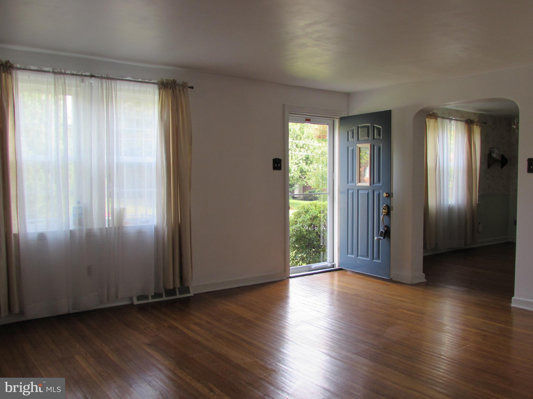 536 Sherman Road Springfield, PA 19064 - Photo 3 of 18 an empty room with wooden floor and windows