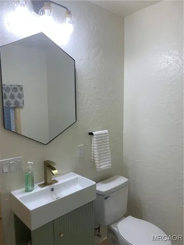 a bathroom with a toilet a sink and bathtub