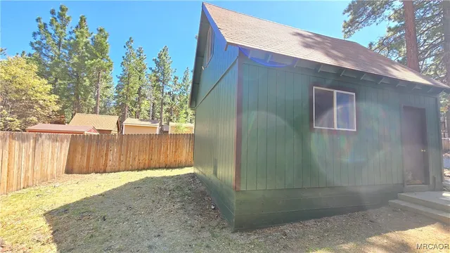 a room with a refrigerator and a window