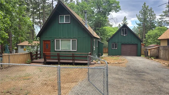 a front view of a house with sitting area