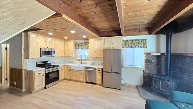 a view of a hallway with wooden floor and furniture