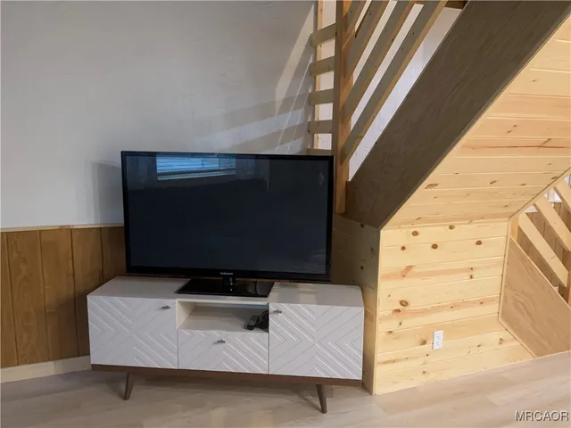 a bedroom with a bed next to a window