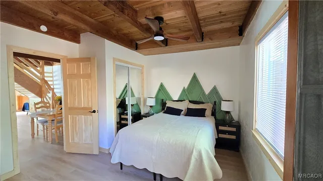 a kitchen with stainless steel appliances kitchen island granite countertop a refrigerator a stove and a sink with wooden floor