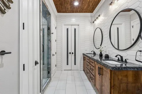 a bathroom with a double vanity sink and a mirror