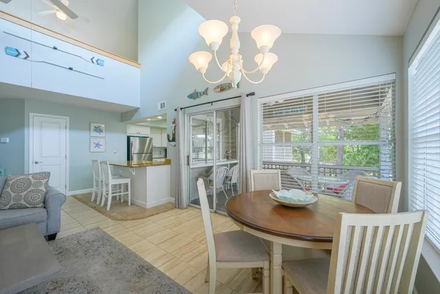 a living room with furniture a wooden floor and a chandelier