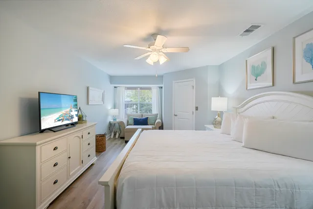 a spacious bedroom with a bed and a chandelier