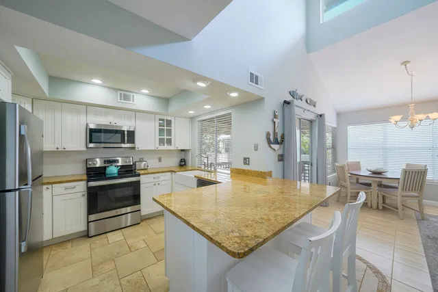 a open kitchen with a sink and cabinets