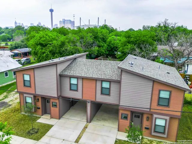 a aerial view of a house next to a yard