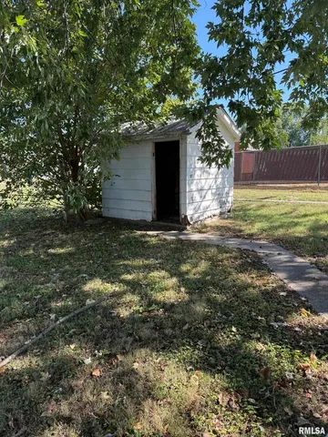 a tree is standing in between the yard