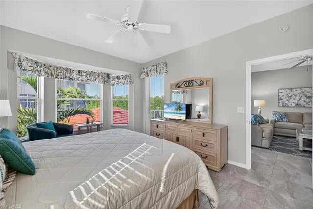 a bedroom with a large bed and a chandelier