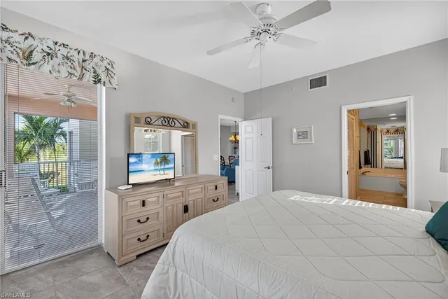 a bedroom with a bed a dresser and next to a window