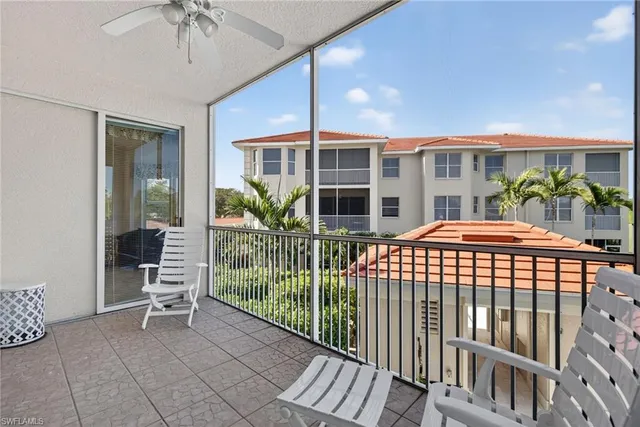 a porch with a table and chairs