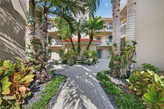 an aerial view of residential houses with outdoor space and ocean