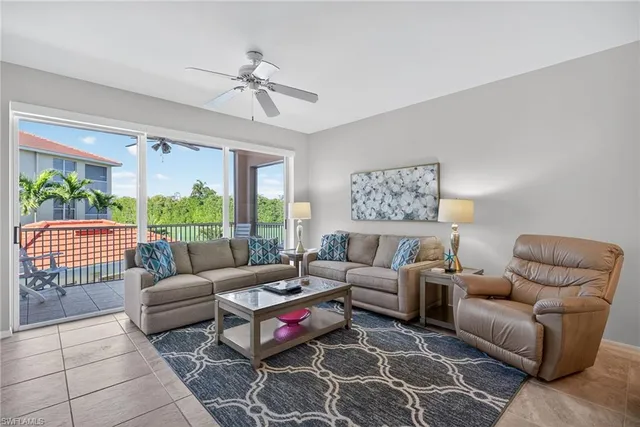 a living room with furniture a table and a large window