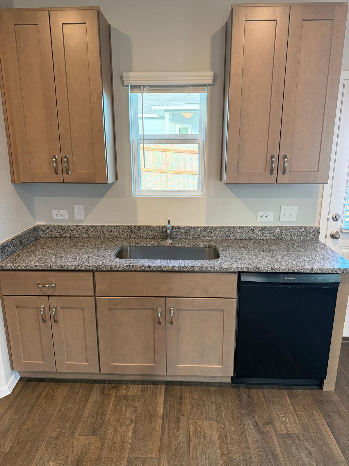 2708 Towy Road Pflugerville, TX 78660 - Photo 12 of 34 a kitchen with granite countertop cabinets granite counter tops and a large window