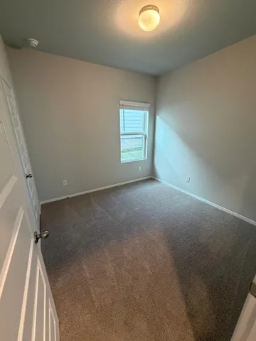 an empty room with wooden floor and closet