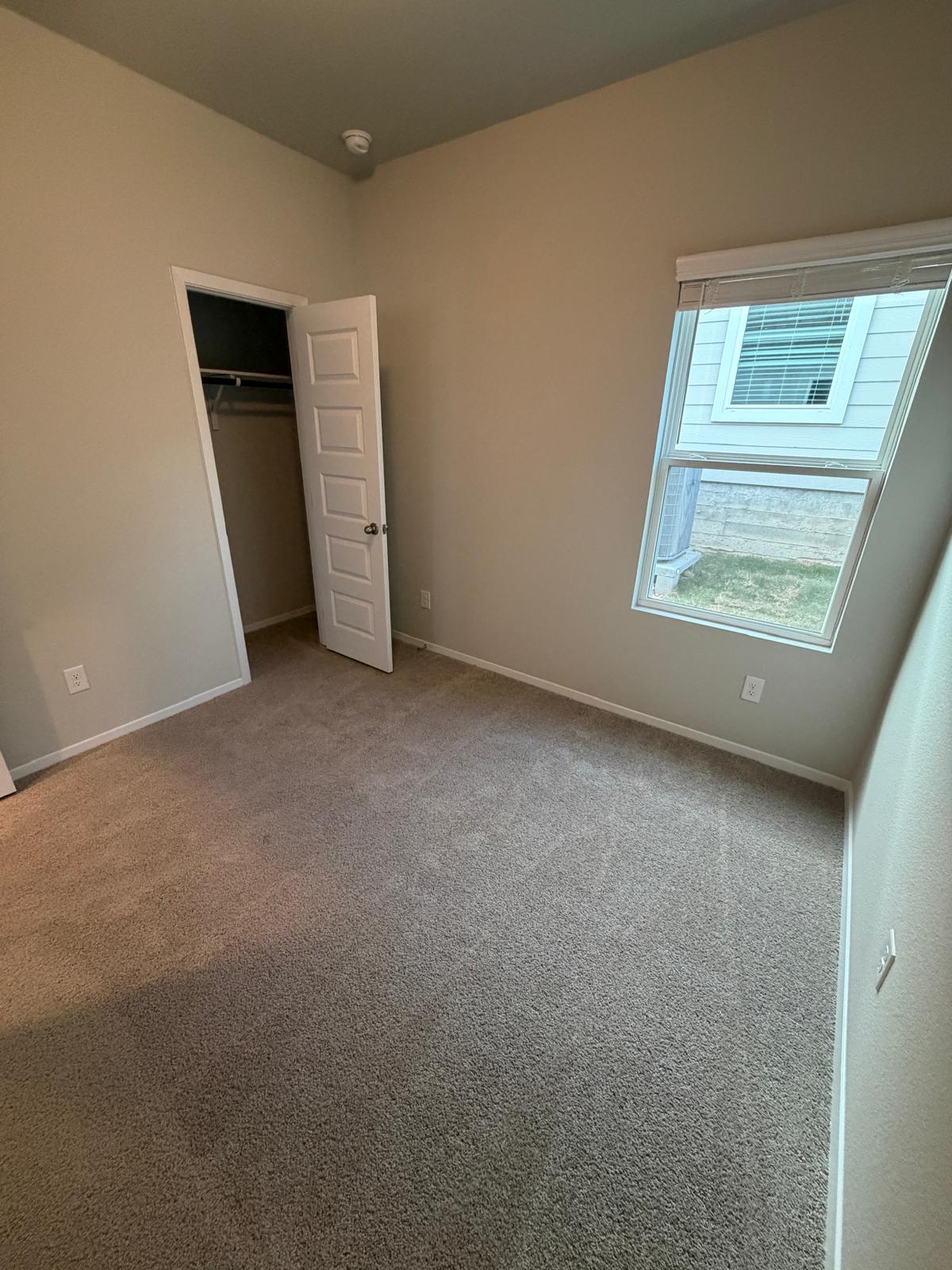 2708 Towy Road Pflugerville, TX 78660 - Photo 31 of 34 an empty room with a window and a ceiling fan