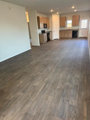 a view of kitchen with refrigerator and window