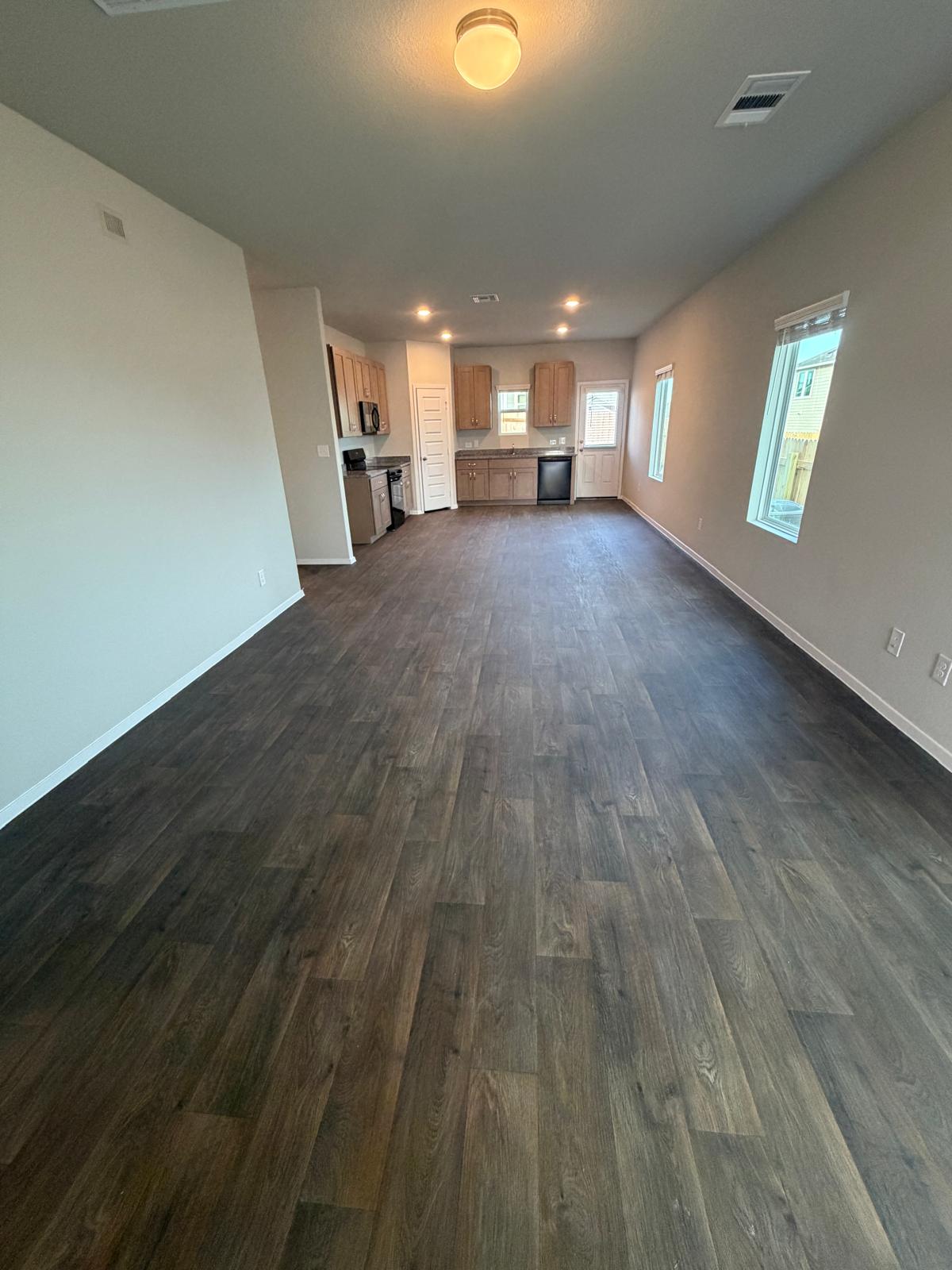 2708 Towy Road Pflugerville, TX 78660 - Photo 9 of 34 a view of a livingroom with wooden floor and staircase
