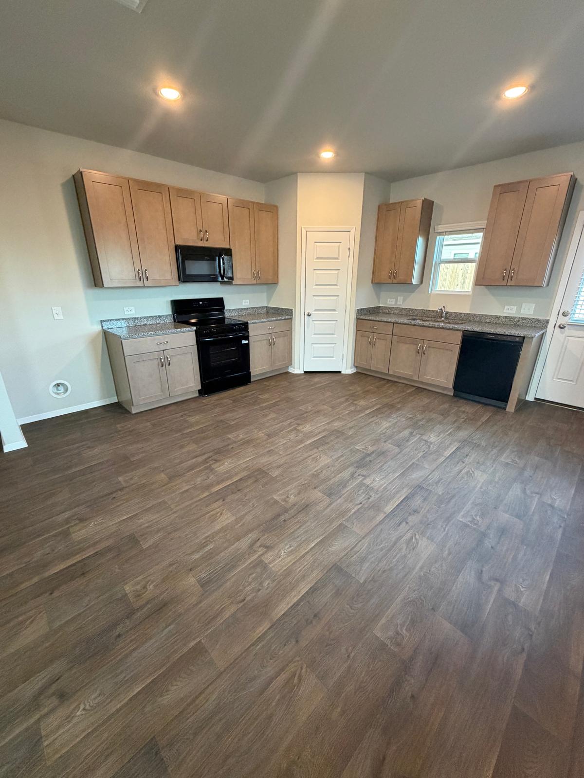 2708 Towy Road Pflugerville, TX 78660 - Photo 10 of 34 a large kitchen with a stove a sink and a refrigerator