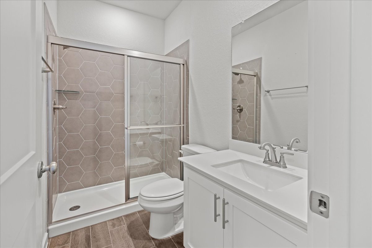 1027 Haystack New Braunfels, TX 78130 - Photo 12 of 15 a bathroom with a sink a toilet and shower
