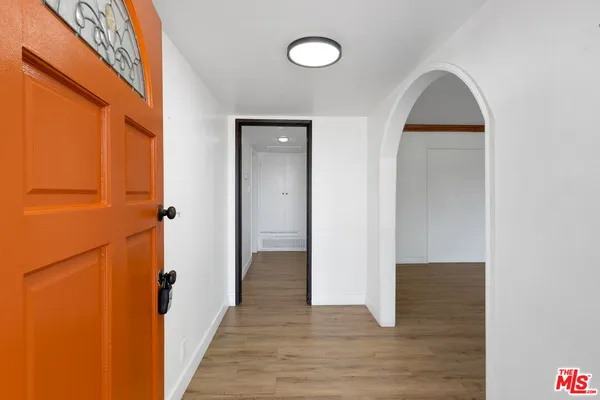 wooden floor fireplace and windows in an empty room