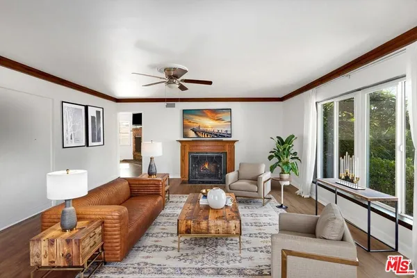 a living room with furniture fireplace and window