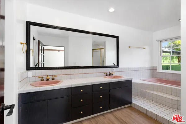 a bathroom with a bathtub and shower