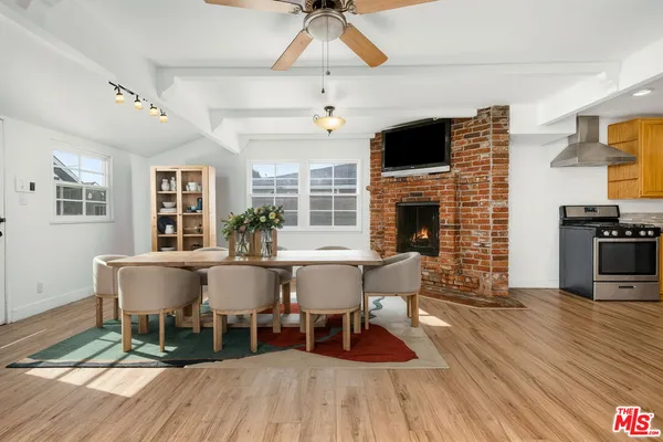 a view of a dining room with furniture wooden floor and chandelier