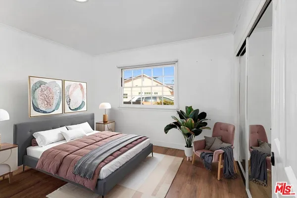 a bedroom with a bed and a chair
