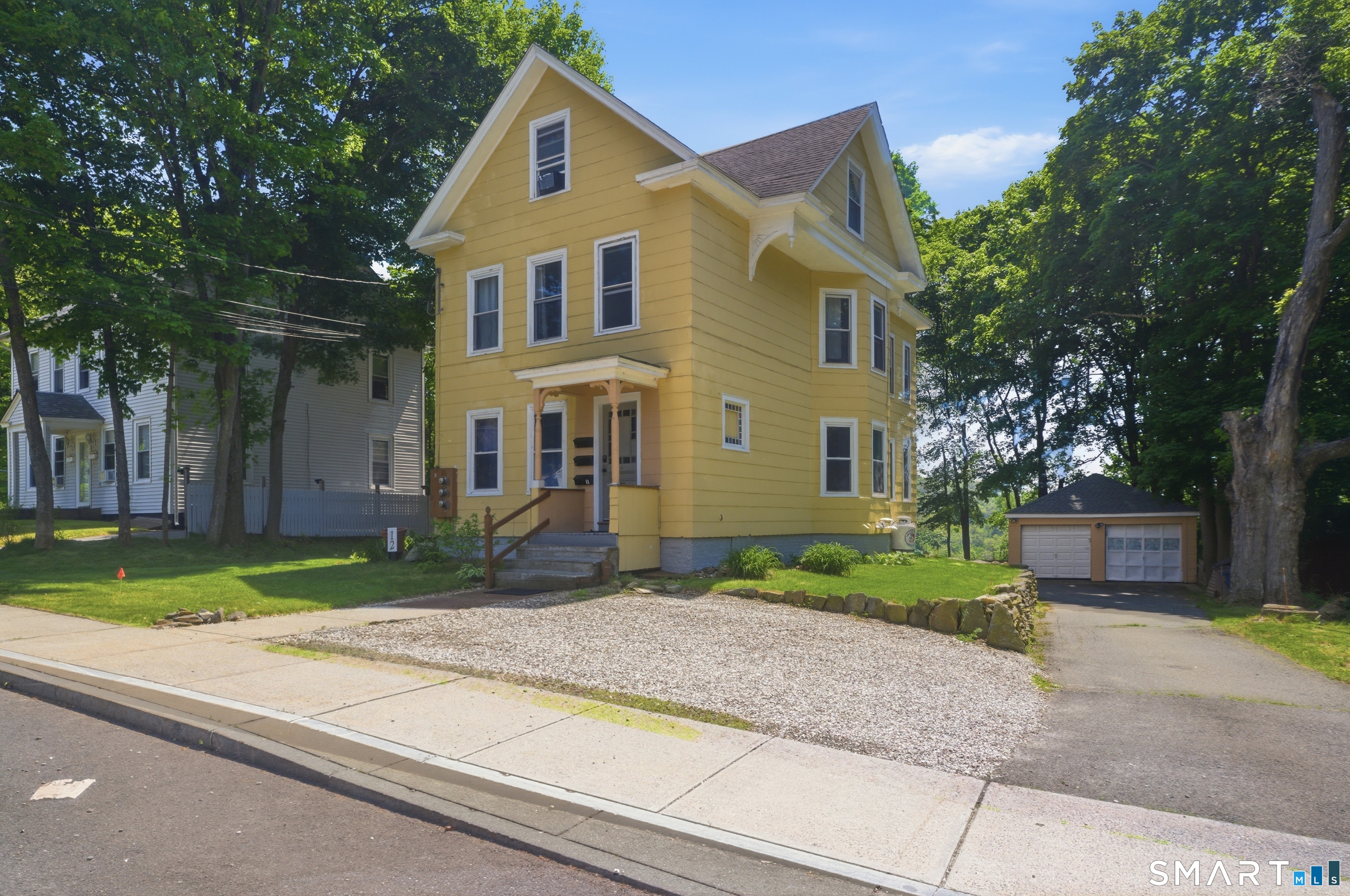 12 Webster Street Vernon, CT 06066 - Photo 1 of 33 a front view of a house with a yard and trees