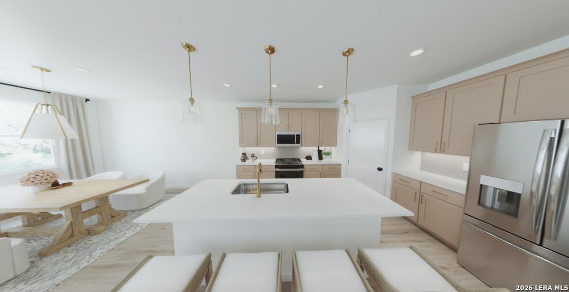 415 Nottabi Road Adkins, TX 78101 - Photo 4 of 7 a large white kitchen with stainless steel appliances