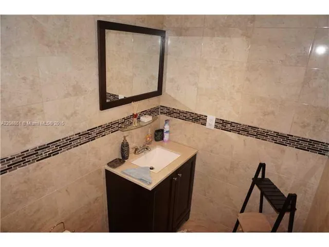a bathroom with a sink mirror and vanity