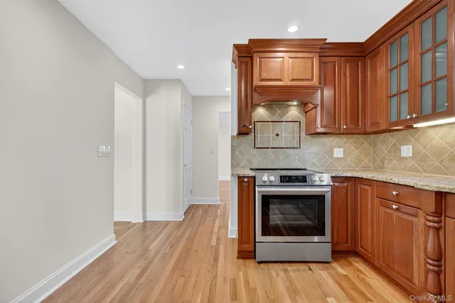 a kitchen with stainless steel appliances granite countertop a stove and a refrigerator