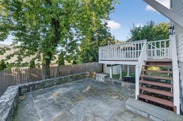 a view of a house with a yard and deck
