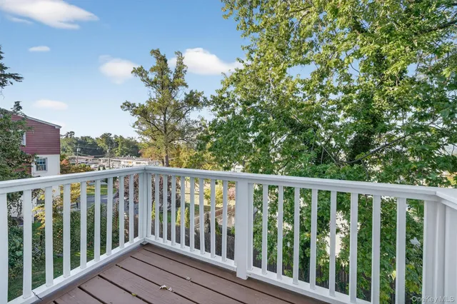 a balcony with wooden floor and fence