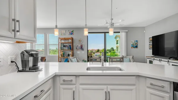 a kitchen with a sink and a refrigerator