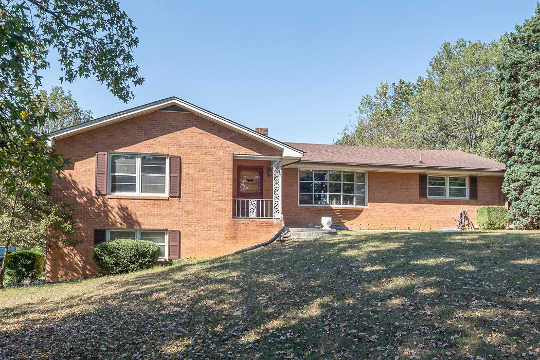 3147 Blue Ridge Boulevard Blue Ridge, VA 24064 - Photo 1 of 57 a front view of a house with a yard and trees