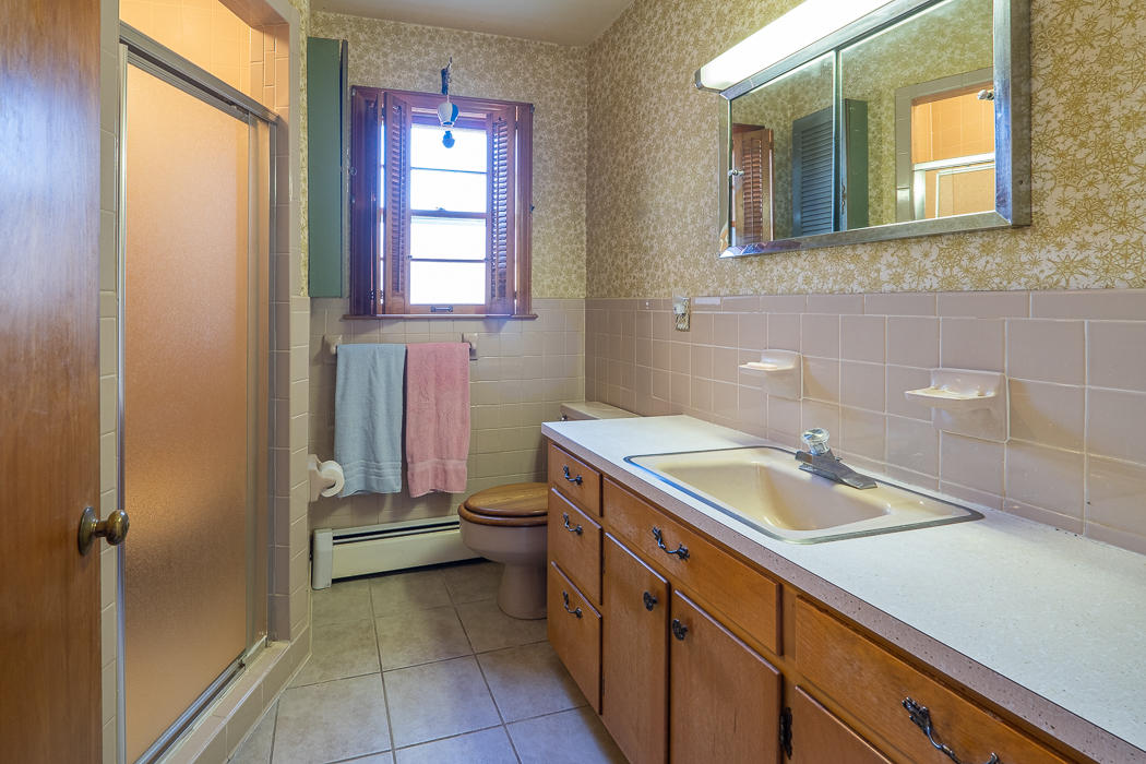 3147 Blue Ridge Boulevard Blue Ridge, VA 24064 - Photo 22 of 57 a bathroom with a granite countertop sink toilet and mirror
