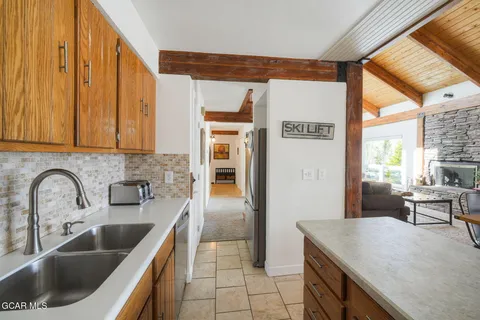 a kitchen with a refrigerator sink and cabinets
