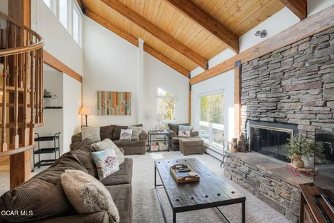 a living room with furniture a fireplace and a table