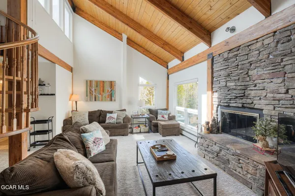 a living room with furniture a fireplace and a table