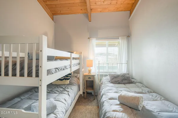 a bedroom with furniture and a window