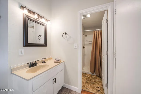 a bathroom with a sink a mirror and a toilet