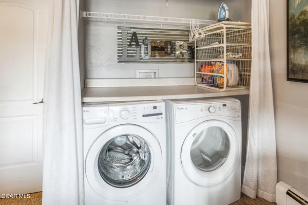 a kitchen with washing machine and a window