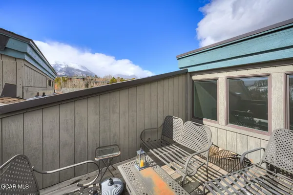 a backyard of a house with table and chairs