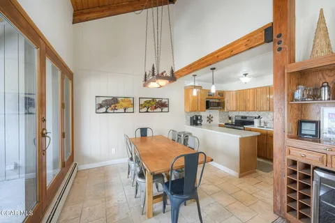 a kitchen with a table chairs and a refrigerator