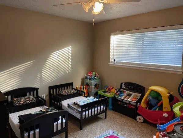 a living room with furniture a rug and a window